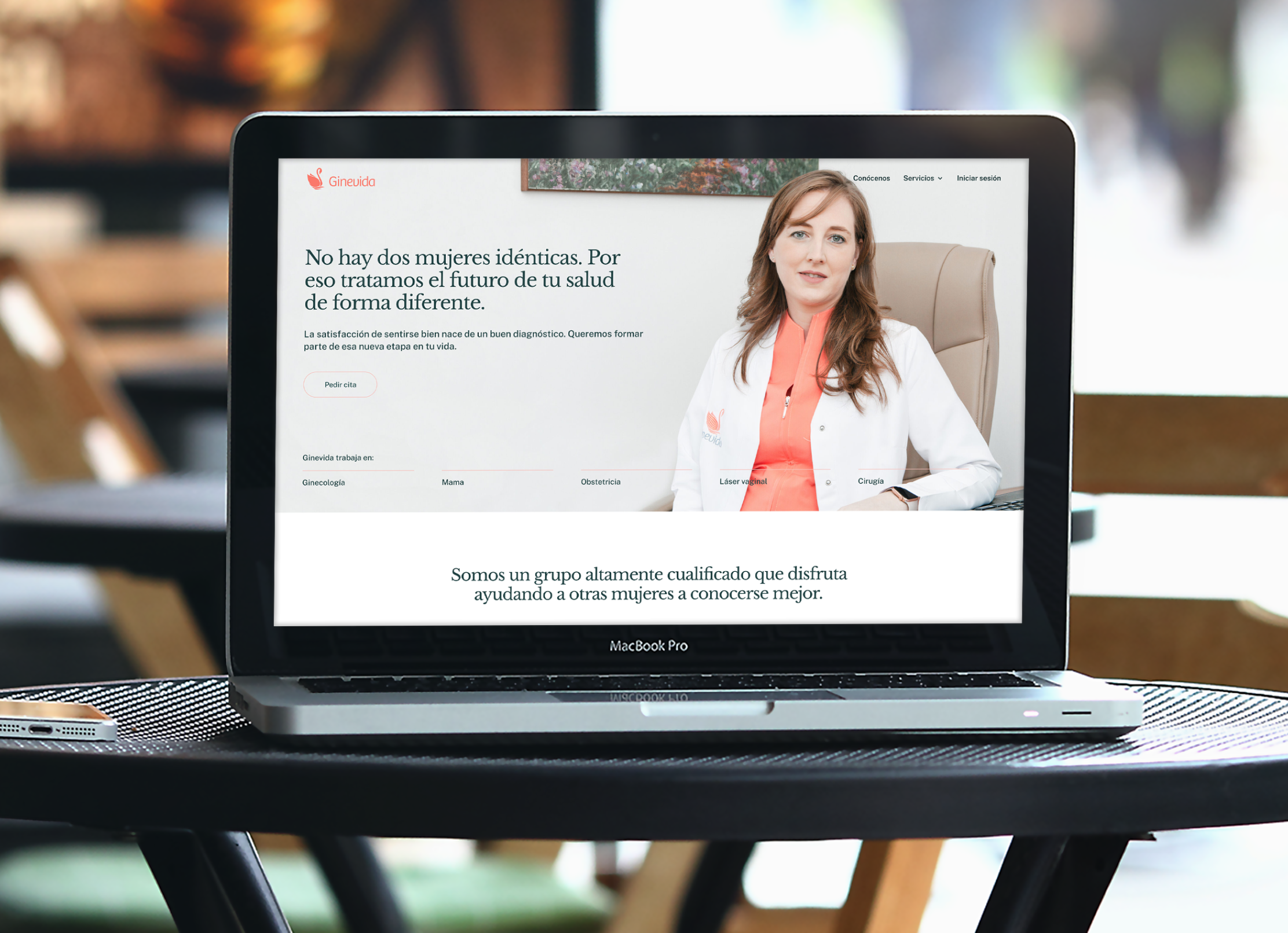 Introducing the case study of Ginevida with a laptop mockup on a table. The hero section of the homepage is shown in the laptop's screen.